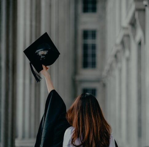 a woman in a graduation cap and gown